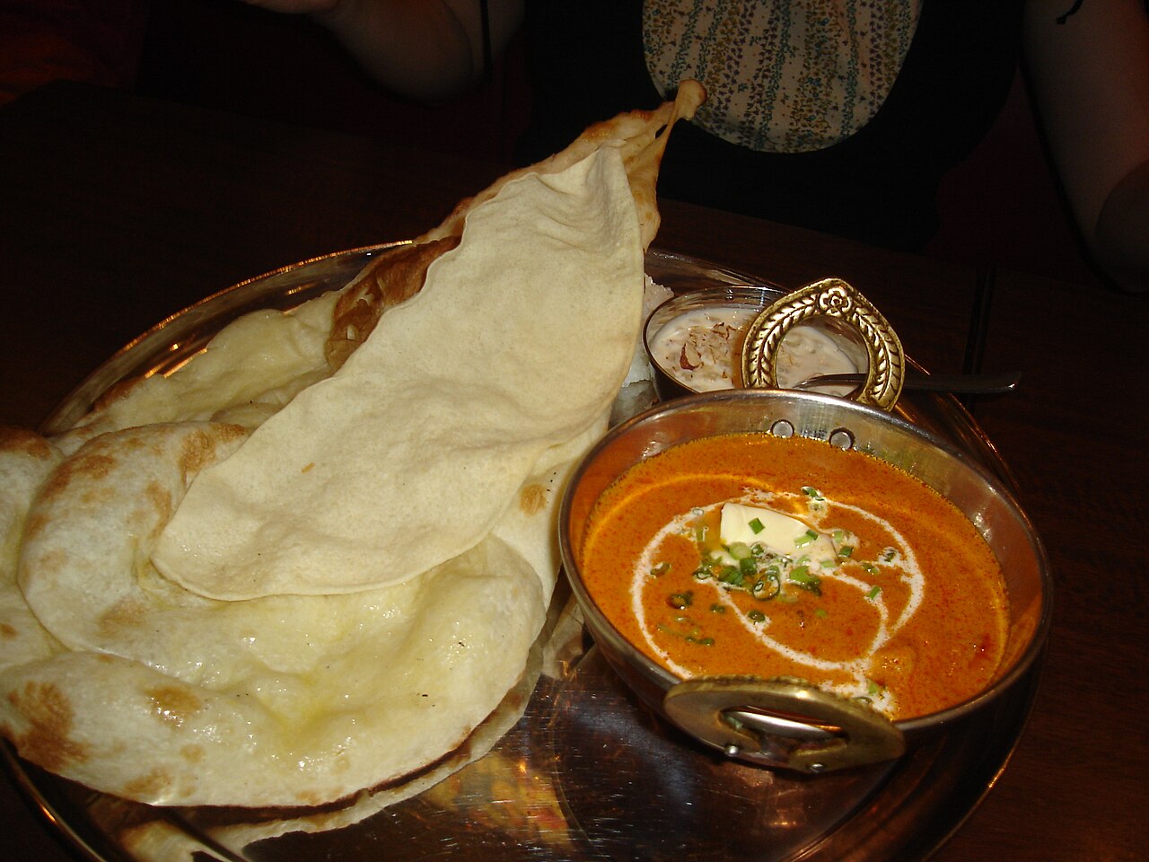 Photograph of Indian butter chicken curry in a rich tomato-based sauce